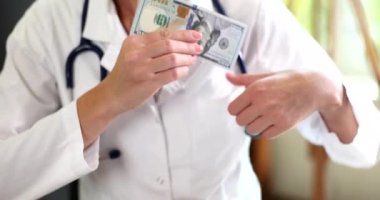 Doctor puts bribe in pocket of medical gown. Bribery corruption and crimes in medicine