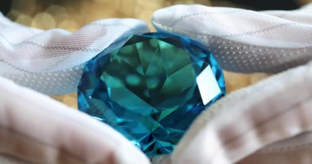 华丽的蓝宝石镶嵌在珠宝商手中 戴着手套 蓝色钻石和暗色 — 图库视频影像