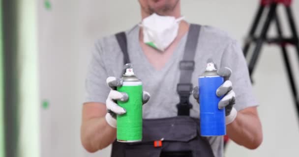 Male Painter Hand Holds Two Aerosol Sprays Paint Cans Choice — Stok video