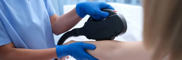 Laser hair removal hair removal on the arms in beauty salon. Skin care and rejuvenation concept