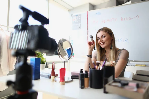 Woman makeup artist conducts makeup training on camera remotely. Blog for ability to paint women concept