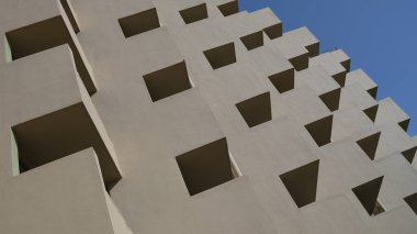 Building profile with concrete beams against sky. Residential complex with balconies