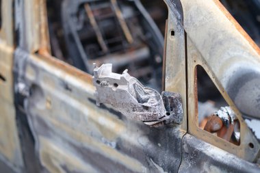 Burnt-out rusty cars on city street, vandalism. Setting fire to cars by vandals and damage to property
