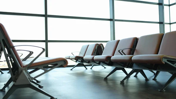 Modern airport waiting area with leather seats. Vacation and travel concept