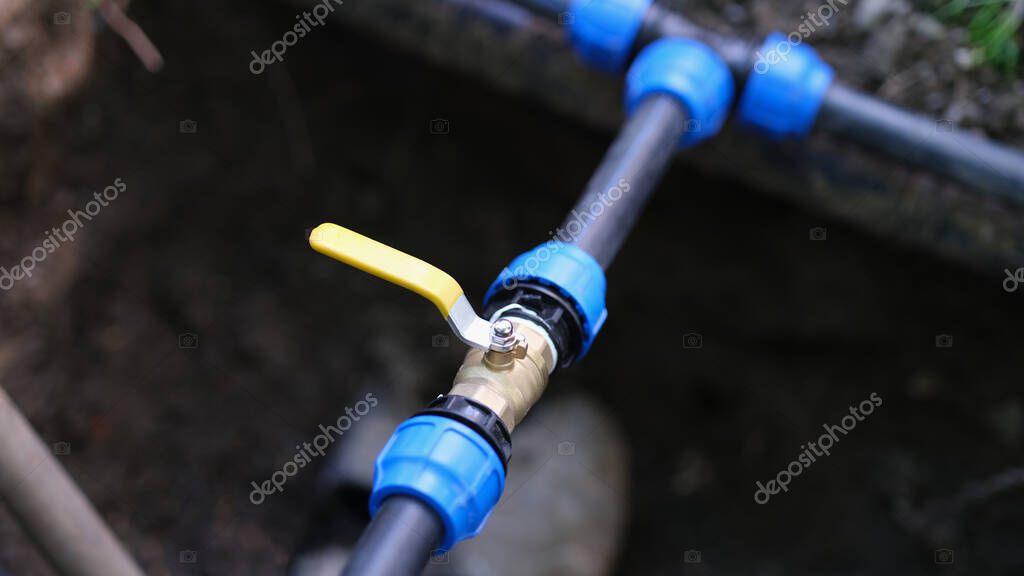 Pvc pipes with tap in ground on garden plot. Installation of