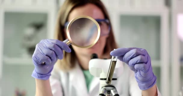 Chemist Examines Test Tube Dark Liquid Crude Oil Magnifying Glass — Stockvideo