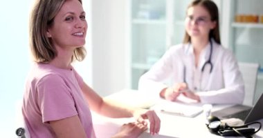 Woman hand showing ok sign with thumb up at doctor appointment. Recommendation of a high level and quality of medical care