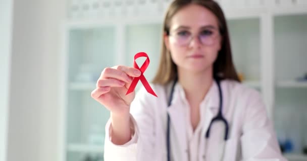 医師は治療に赤いリボンを示し エイズやHivと戦う Hiv検査と早期症状 — ストック動画