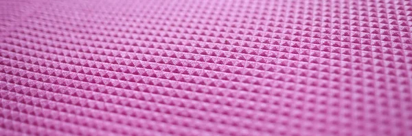 Pink texture of a sports mat and rubber pattern for background. Pink texture in rhombuses concept