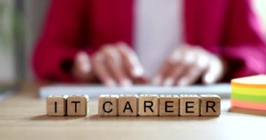 Programmer typing text on keyboard on background of word it career 4k movie slow motion. Programming concept 