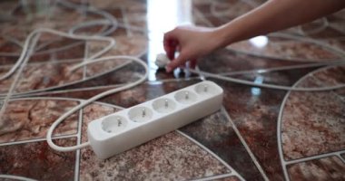 Woman hand inserting electric plug into extension socket closeup 4k movie slow motion. Electricity cost concept 
