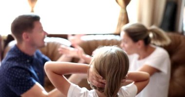 Little girl watching how her parents swearing and covering her ears 4k movie slow motion. Psychological problems in children due to parental conflicts concept 