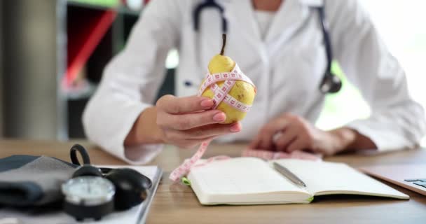 Doctor Nutritionist Holding Pear Fruit Hands Centimeter Tape Closeup Movie — Vídeos de Stock