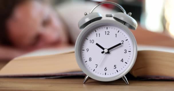 Alarm Clock Standing Table Woman Sleeping Book Closeup Movie Slow — 图库视频影像
