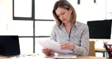 Businesswoman studying information on documents in office 4k movie. Paper work concept