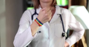 Woman doctor with lgbt bracelet on arm in clinic. Gay nurse or doctor and transgender medical support