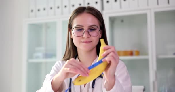Doctor Plastic Surgeon Holds Banana Measuring Tape Hands Penis Enlargement — Stok Video