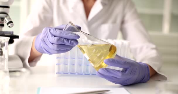 Hands Holding Flask Yellow Liquid Chemical Laboratory Closeup Quality Control — Αρχείο Βίντεο