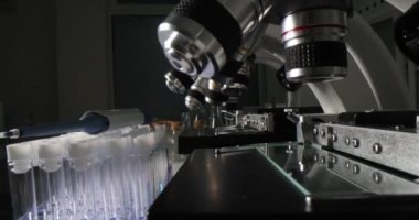 Microscopes and test tubes on table in chemical laboratory closeup 4k movie slow motion. Pharmaceutical industry concept