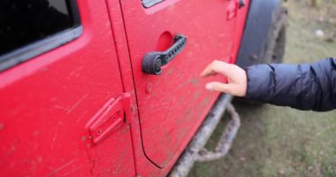 Tourist driver opens off-road door in forest. Off-road driving for travelers