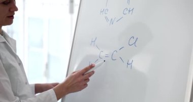Scientists write chemical formula on a white board in laboratory. Compilation of chemical formulas and education