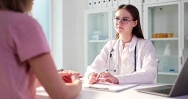 Doctor therapist or gynecologist listens to a woman with health problems in clinic. Therapist professional advice healthy lifestyle concept