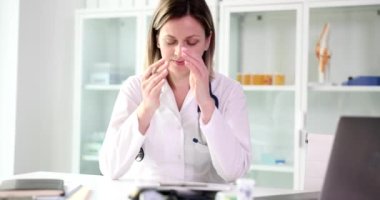 Frustrated female doctor upset by medical mistake in clinic. Emotional and psychological stress of medical staff