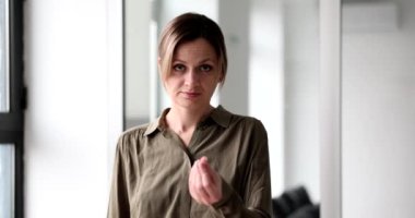 Woman in shirt showing gesture asking for money 4k movie slow motion. Delayed salary concept