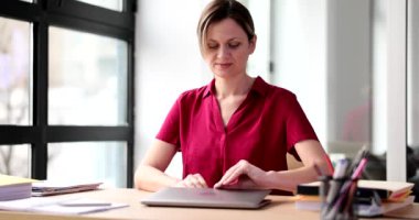 Businesswoman opening laptop lid and starting working day at office 4k movie slow motion. Professional consulting and audit concept