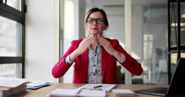 Happy beautiful businesswoman showing air kiss to those sitting at table. Seo or manager secretary smiling friendly in office