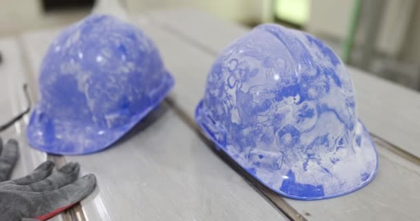 Dirty Protective Construction Helmets Lying Floor Laminate Closeup Movie Slow — Vídeo de stock