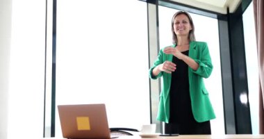 Beautiful smiling business woman standing in office with arms crossed. Serious business job offer and excellent education