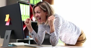 Excited happy woman looking at computer screen. Businesswoman rejoices in good news and financial profit