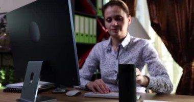 Smiling businesswoman freelancer turns on desktop humidifier on table. Home air humidifier