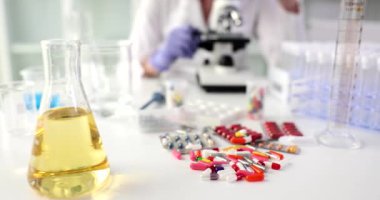 Science lab researches safe new medicines microscope and different pills. Pharmaceutical industry and drug development