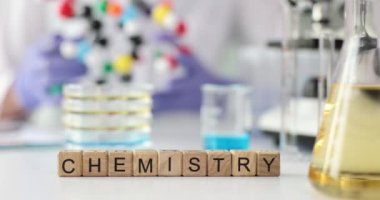 Word chemistry laboratory table with microscope laboratory glassware and molecular structure. Concept of science education, laboratory research