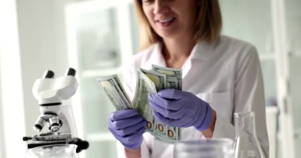Woman Working Science Laboratory Smiles Holds Money Scientist Doctor Positively — ストック動画