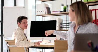 Smiling business woman with colleague punching in office.Successful employees or students greet each other