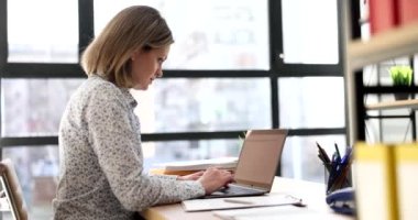 Serious focused business woman working on laptop. Programmer time management and workplace