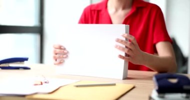 Businesswoman manager holds a lot of documents or white blank sheets of a4. Archive documentation company bureaucratization and development barrier