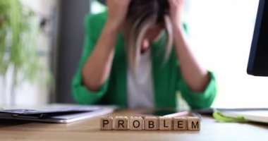 Stressed woman with problems holding head with hands in office. Upset business woman and bad day and burnout at work