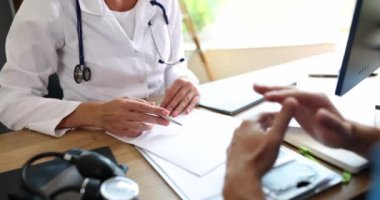 Doctor and patient discuss consultation about diagnosis of problems with symptoms of disease. Therapist talking to patient about medications and treatments