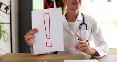 Doctor shows information on paper exclamation mark. Doctor warns of possible infection with seasonal flu virus