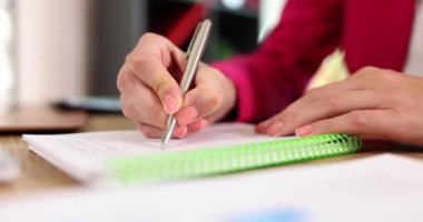 Business woman writes with pen in notebook planning affairs for day. Learning education and creative business ideas notes