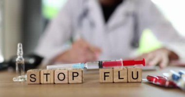 Stop flu word and syringe with vaccine. Medicine treatment and the beginning of vaccination