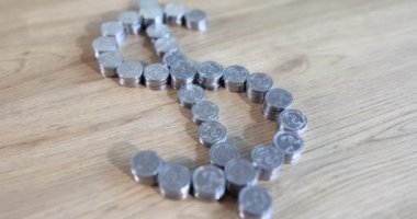 Dollar sign from stack of coins closeup. Best deposits in US currency