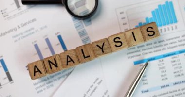 Business chart analysis chart and magnifying glass on table. Financial development and statistics