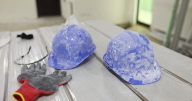 Blue construction helmets gloves and goggles closeup. Construction safety and protective equipment