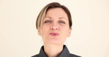 Portrait of beautiful woman blowing a kiss with lips. Emotions of love happiness joy and love