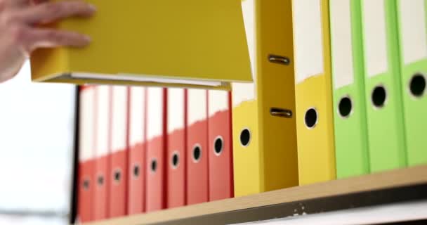 Woman Hand Puts Yellow Folder Shelf Business Documentation Document Archive — Stok video
